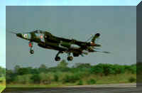 A Jaguar takes off, landing gear still extended